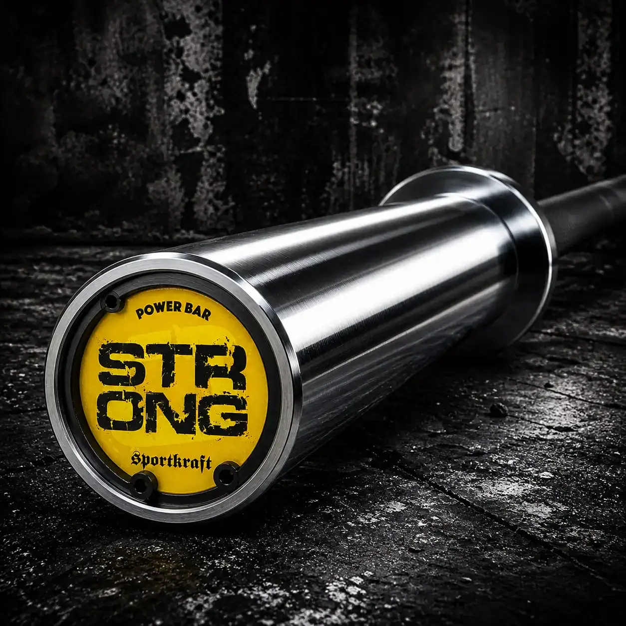 ähikuva SportKraft Strong voimanostotangon päädystä ja keltaisesta Strong Power Bar -logosta